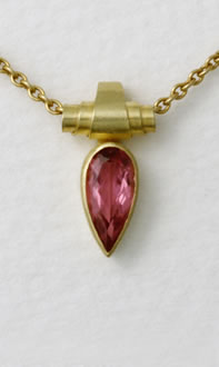 Scroll with pink Tourmaline drop on yellow gold trace chain